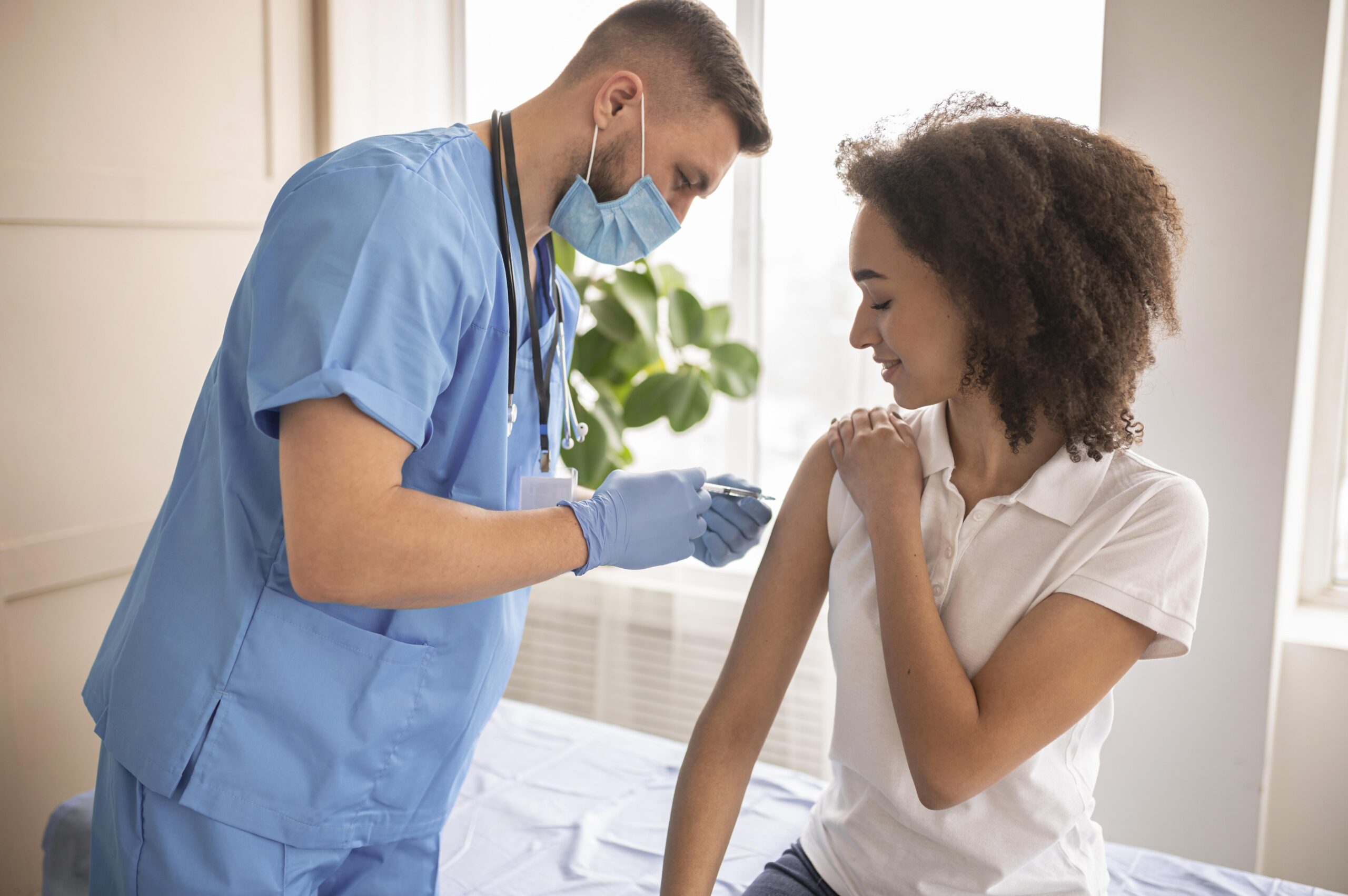 doctor vaccinating patient clinic